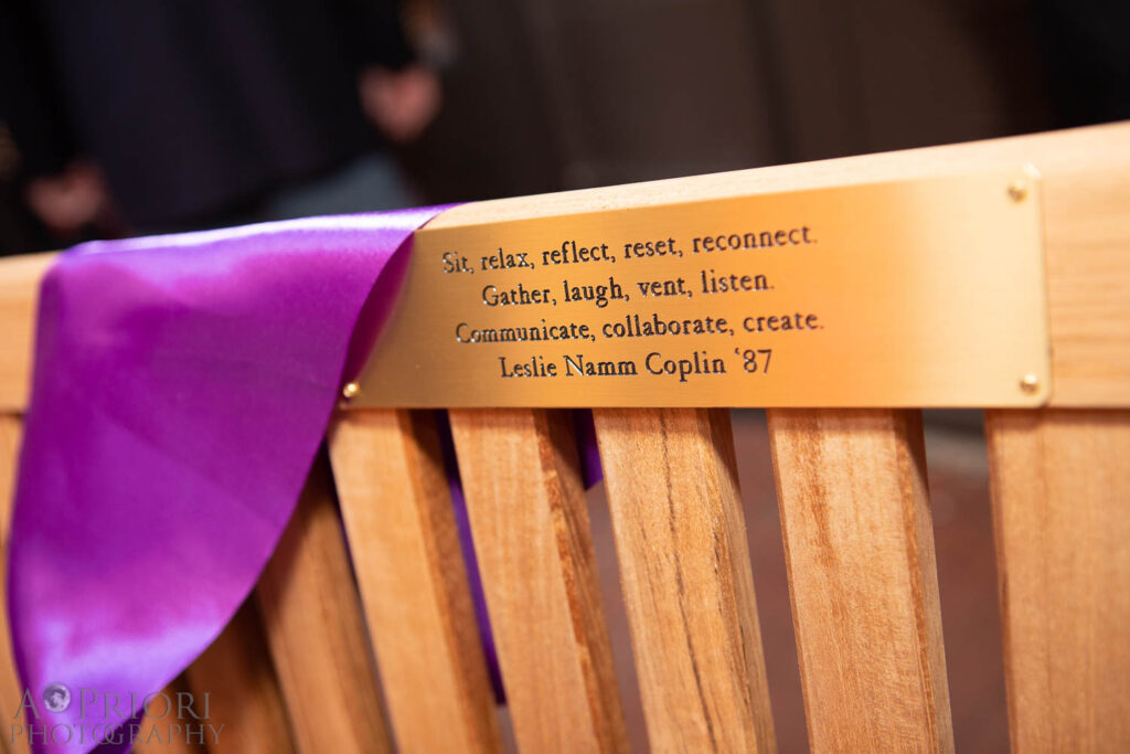 Closeup of the inscription honoring Leslie Coplin on one of the benches