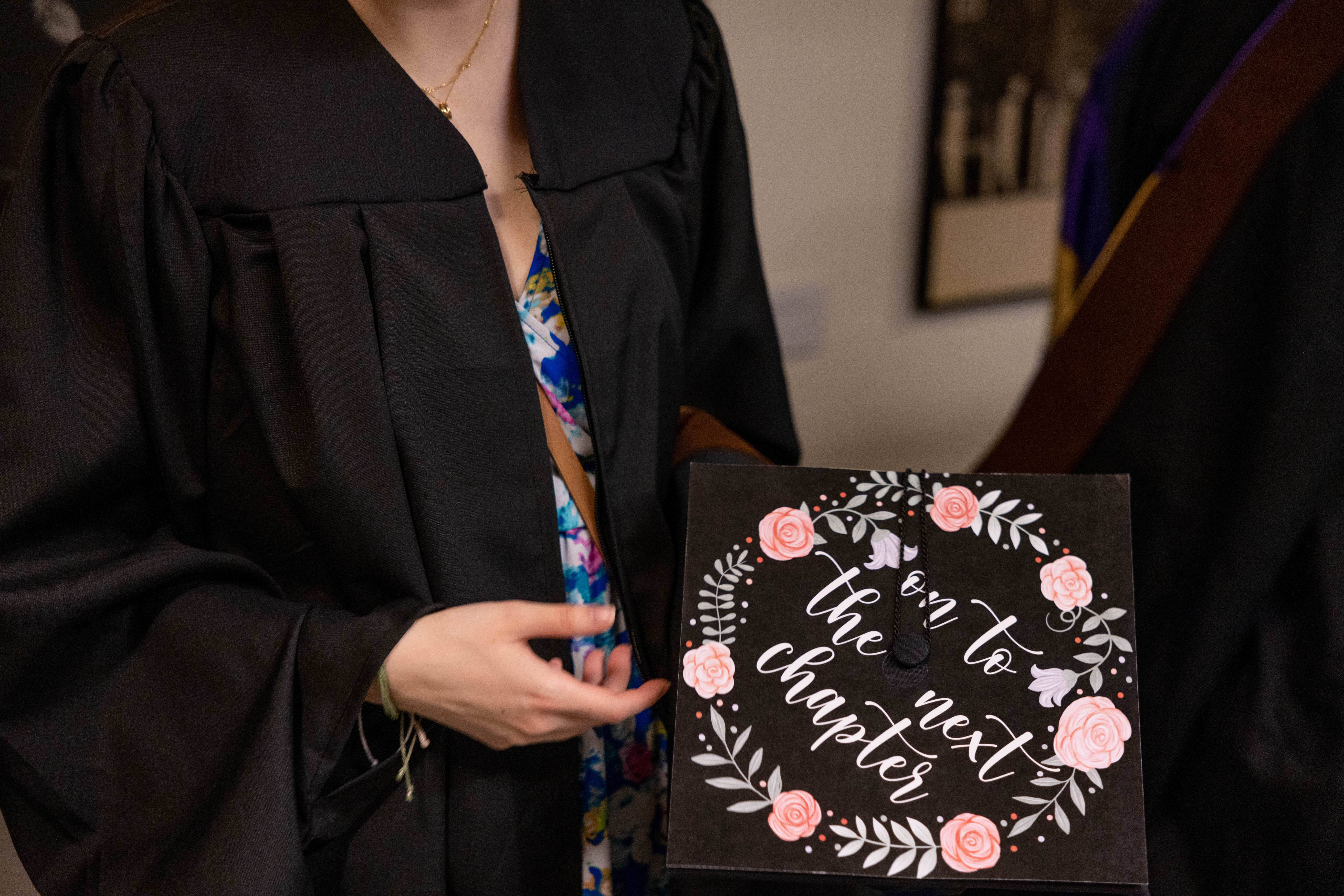 'On to the next chapter' adorns someone's graduation cap