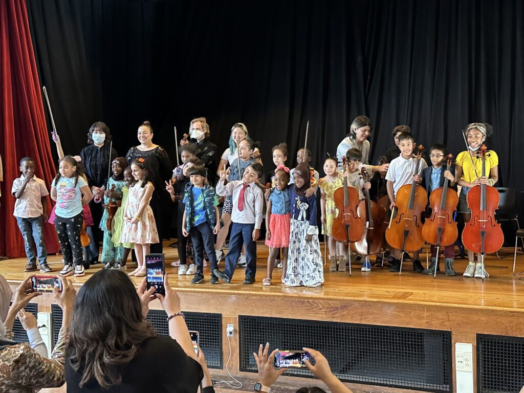 Students stand for applause after a Boston Music Project performance.