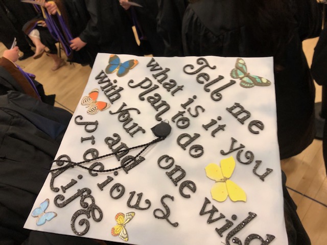 Graduation cap says: Tell me what is it you plan to do with your one wild and precious life