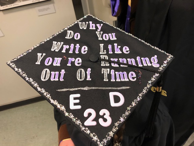 Graduation cap says: Why do you write like you're running out of time