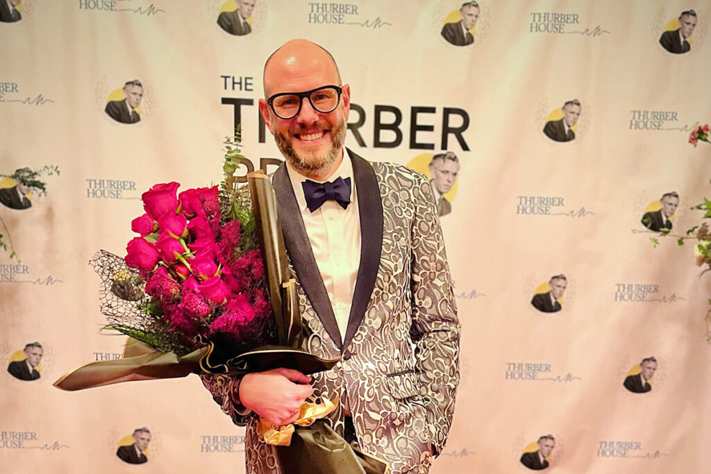 Steven Rowley, wearing a tuxedo, holds a bouquet