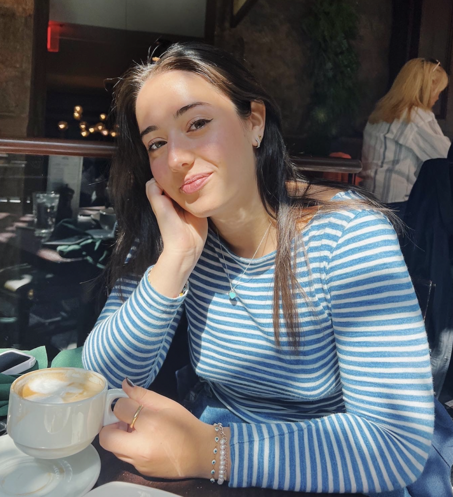 Amanda Miller sits with a cup of coffee