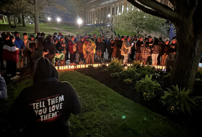People participate in a nighttime commemoration of the Kent State massacre