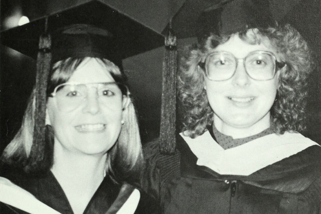 Marsha and Marilyn Manter in caps and gowns in black and white photo from the 1980s