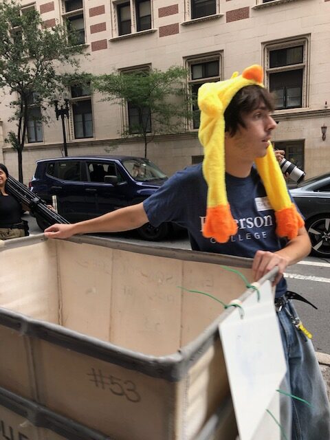 A move-in helper dons a chicken hat