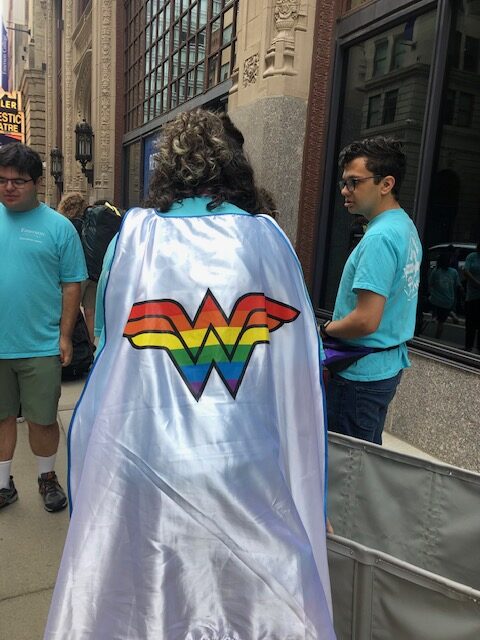 A rainbow symboled cape worn by an orientation leader