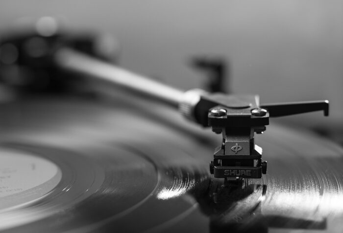 a record needle plays on a record table
