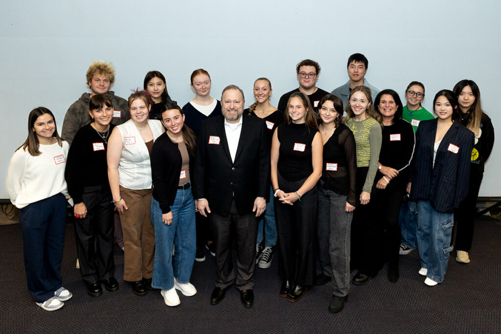 Jay Bernhardt and Cathryn Edelstein surrounded by Edelstein's students