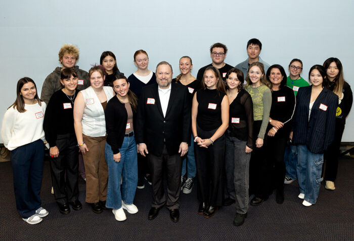 Jay Bernhardt and Cathryn Edelstein surrounded by Edelstein's students