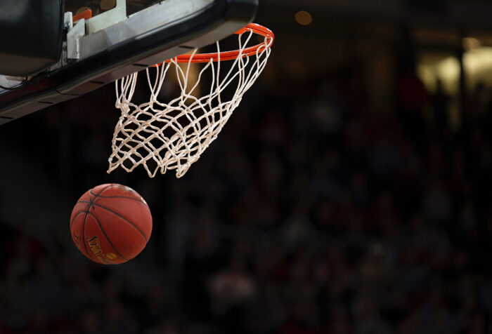 Basketball going falling through bottom of net
