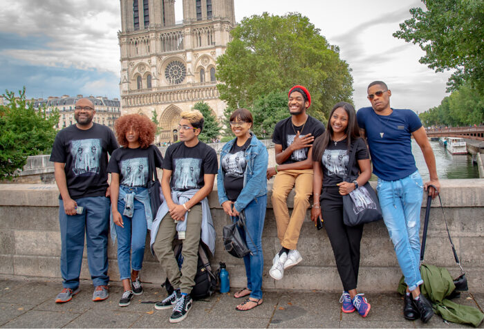 students and faculty of color in front of Notre Dame Cathedral in Paris