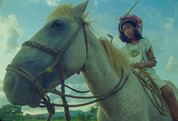 Close-up of a girl sitting on a horse