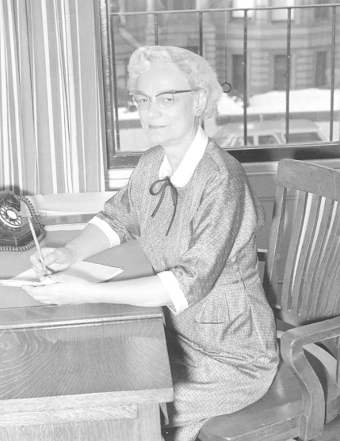 Catherine Perry sits at a desk