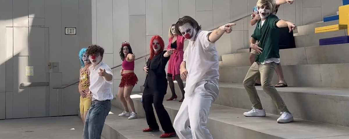 students dressed as clowns dance on steps at Emerson LA
