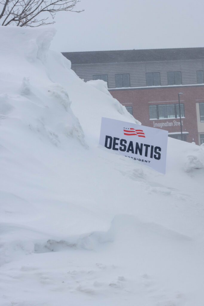 A Ron DeSantis sign stuck in a snowbank