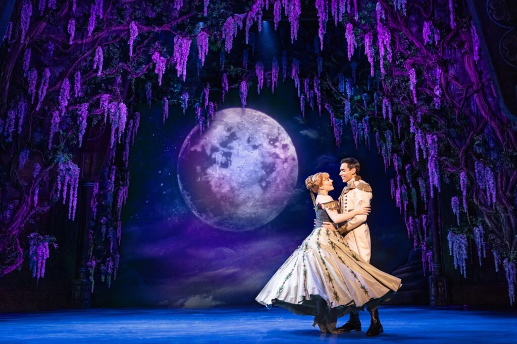 Lauren Nicole Chapman as Anna embraces Preston Perez as Hans on stage