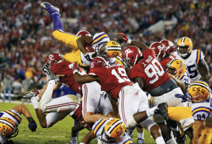 LSU football player tries to jump over pile of Alabama players