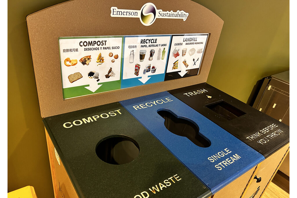 Compost, trash, and recycling bins next to each other with signs that show what materials go into each receptacle