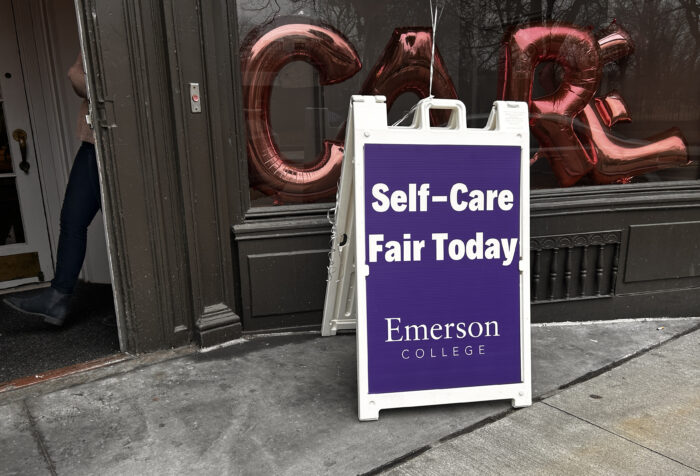 Sandwich signs says: Self-Care Fair Today