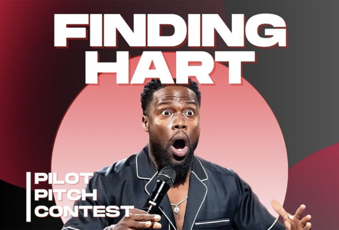 Kevin Hart looks surprised while holding a microphone