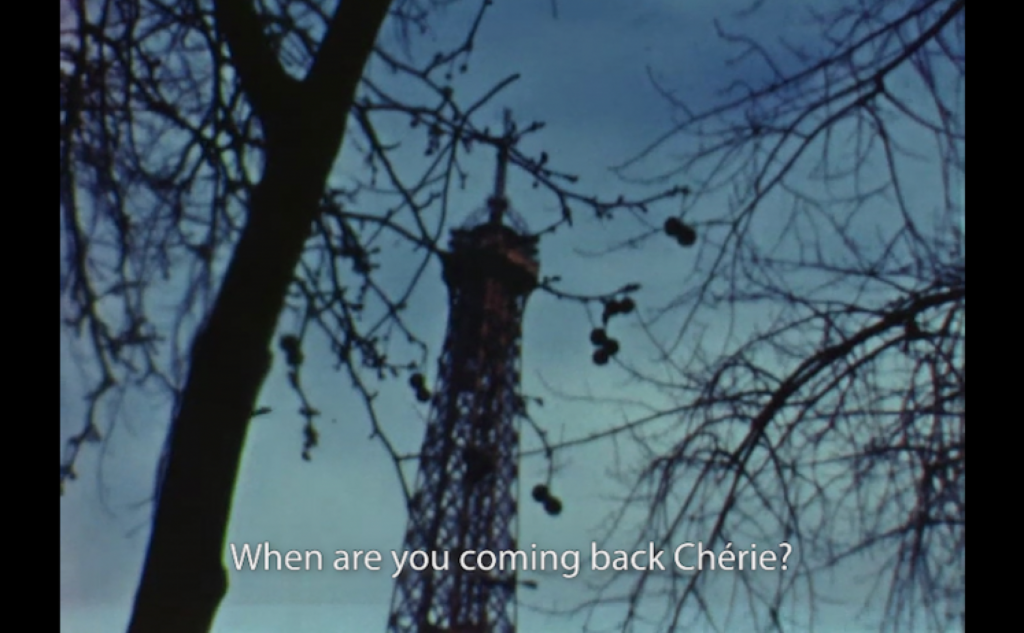 Barren trees with the top of a tower in the background with a caption that reads: When are you coming back Cherie?