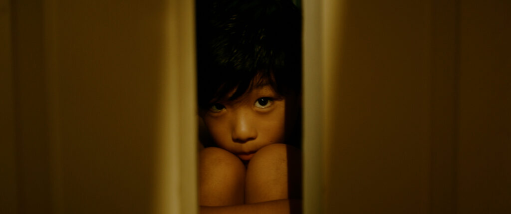 A child peeks through a closet