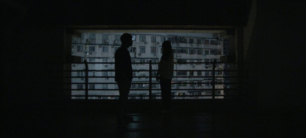 Silhouettes of two people with a background in the back
