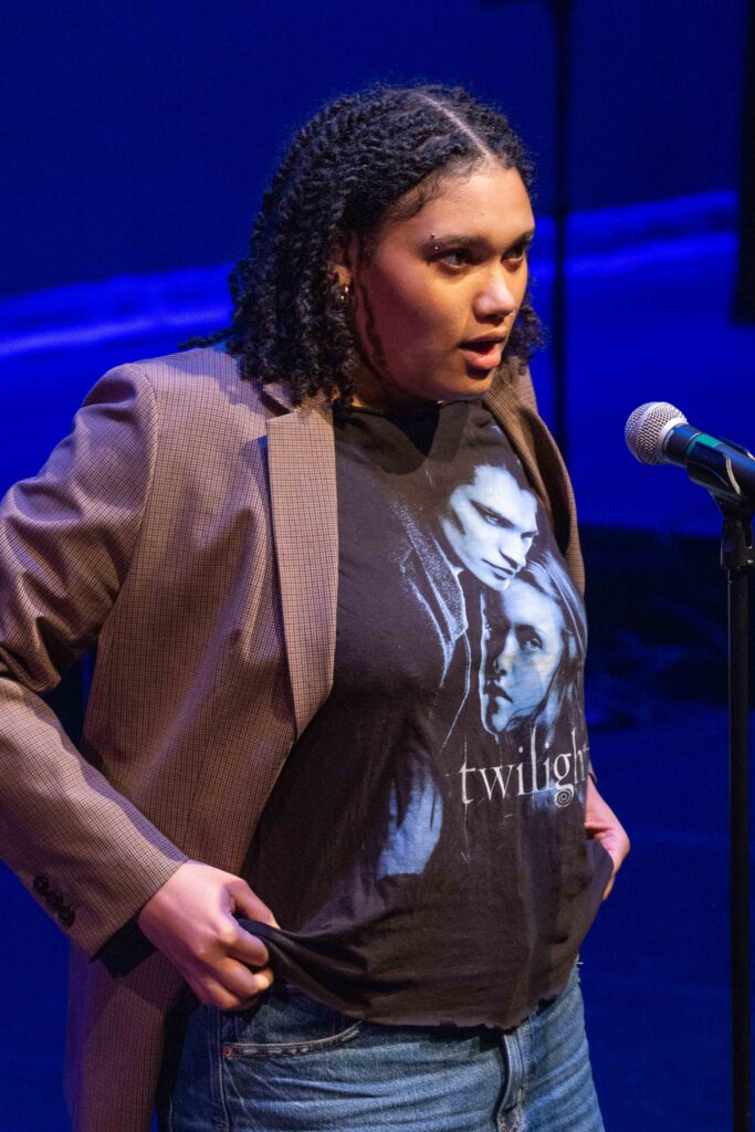 Devin Hill performs by showing her Twilight t-shirt