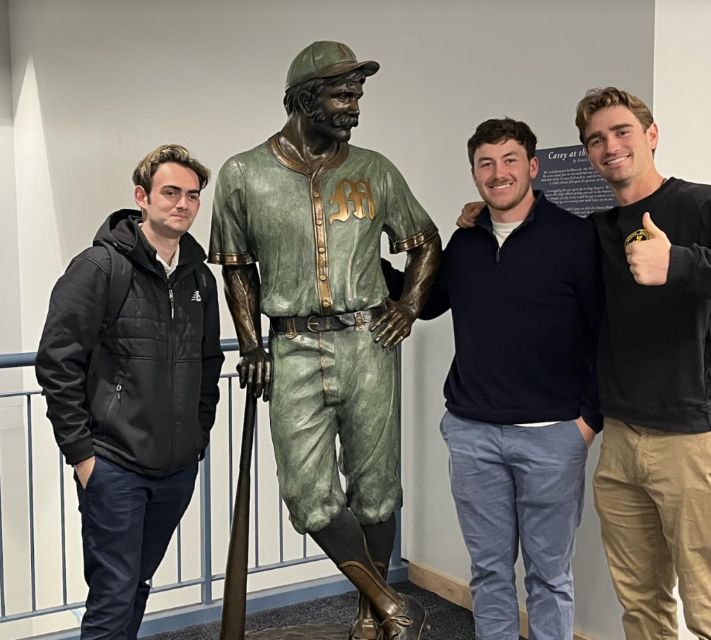 Michael Letendre, Aidan Rice and Chris Ferara pose with a Worcester WooSox baseball statue