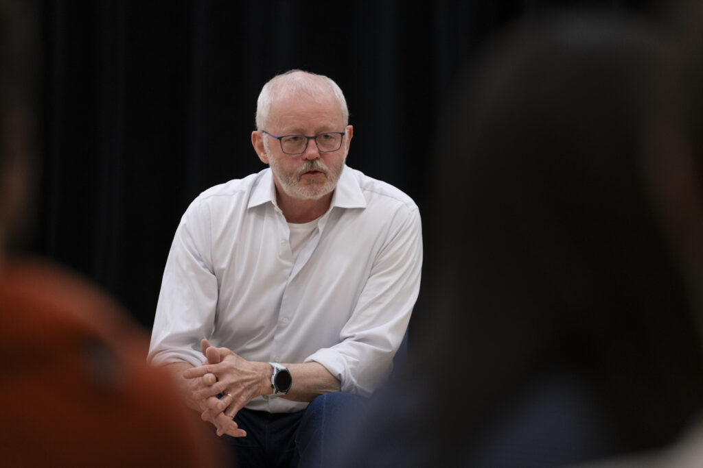 David Morse sits while speaking to students