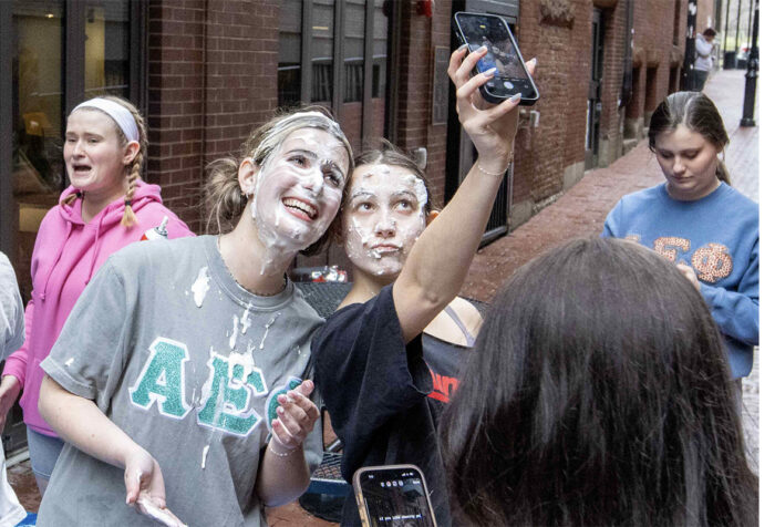 Phoebe Alves and Sofia Mendes take a selfie after being pied in the face