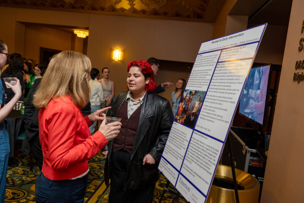 STUDENT SCHOLARS & CREATORS SHOWCASE; Carter Castaneda ’26 shows off her Access to Early Intervention poster.