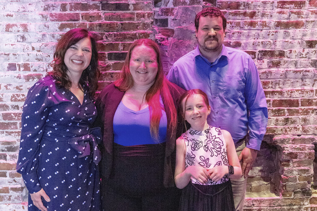STUDENT SCHOLARS & CREATORS SHOWCASE; Assistant Dean Lisa Wisman Weil poses with Megan Marr O’Neil and her family.