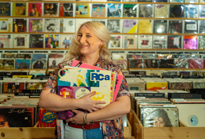 Alexa Lash hugs a record in a record store