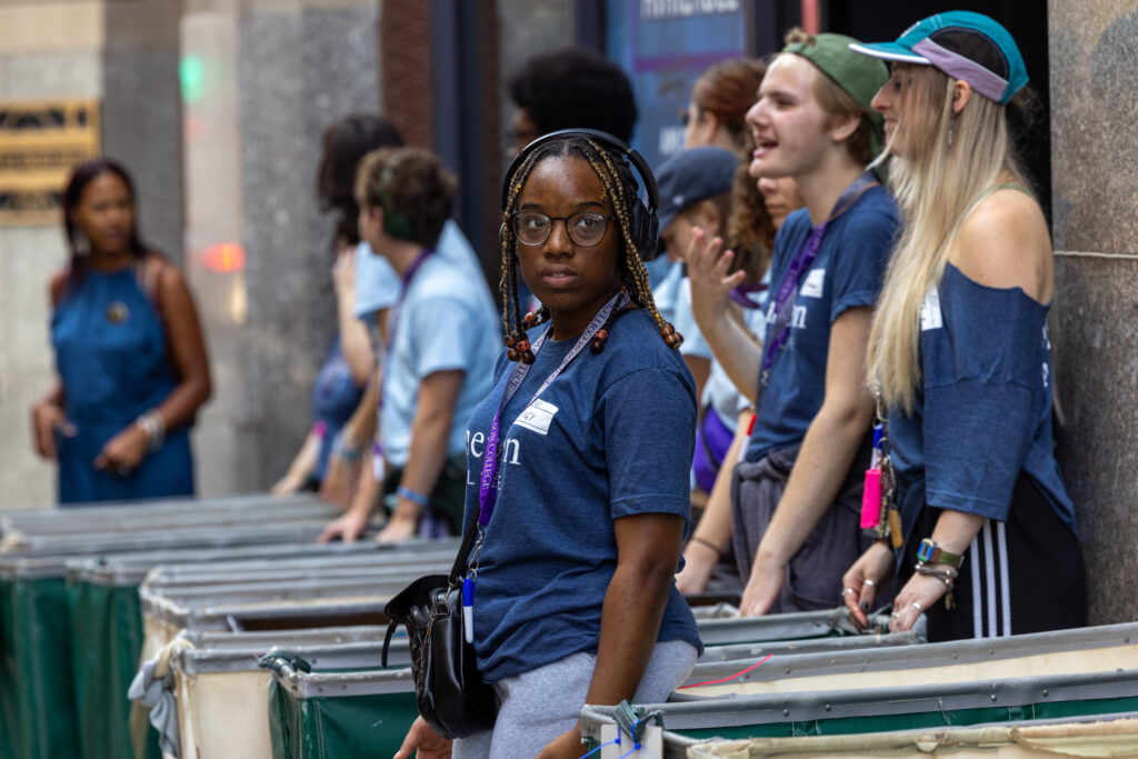 Orientation leaders line up with rolling carts