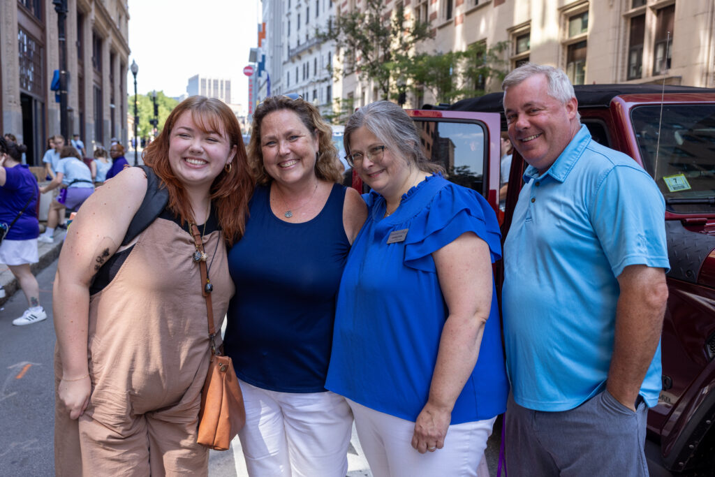 The Cunniff family with Andrea Popa smile together on the street