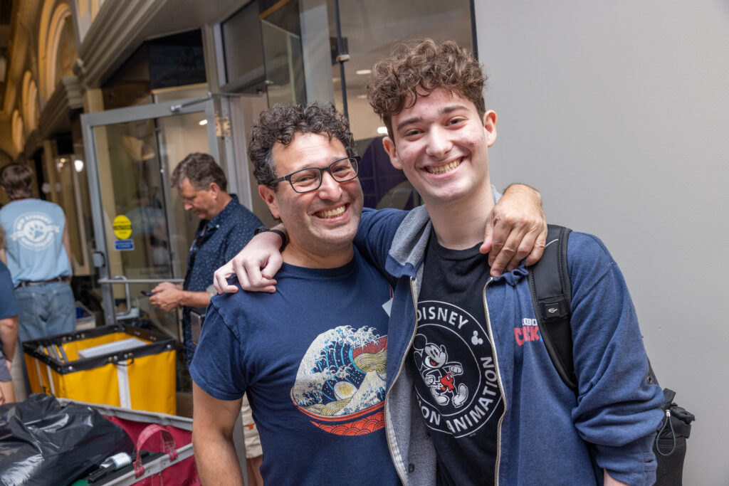 a father and son smile together