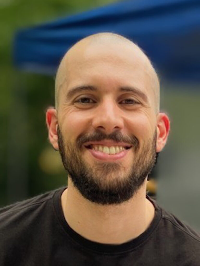 bald man with brown beard wearing black t-shirt