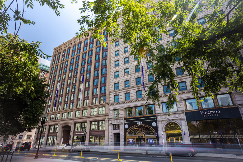 Emerson buildings along Boylston Street, with cars zooming by in foreground