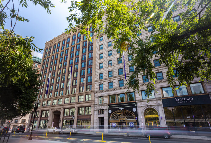 Emerson buildings along Boylston Street, with cars zooming by in foreground