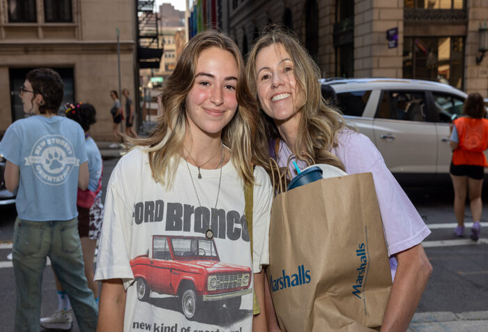 A mother and daughter smile during move-in