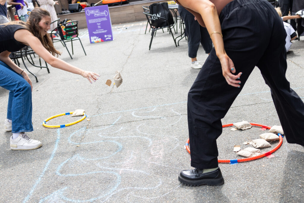 A person tries to throw a beanbag as part of a game