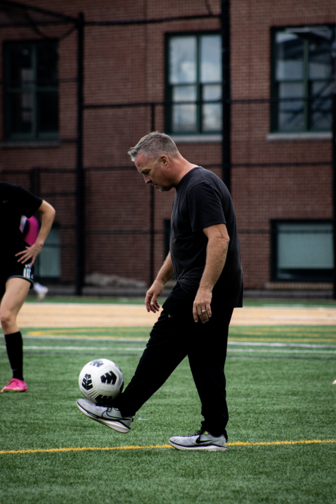 Head Coach David Suvak juggles the ball