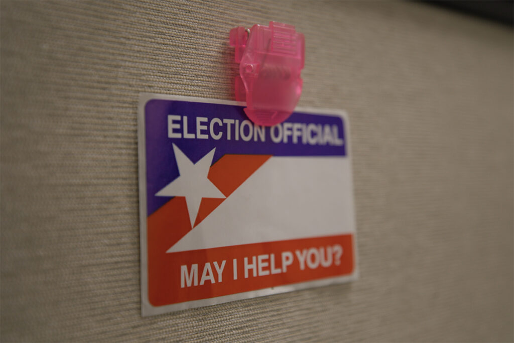 A sticker says: election official may I help you?