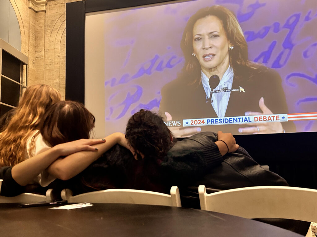 Students watch the presidential debate from the Bordy Theatre