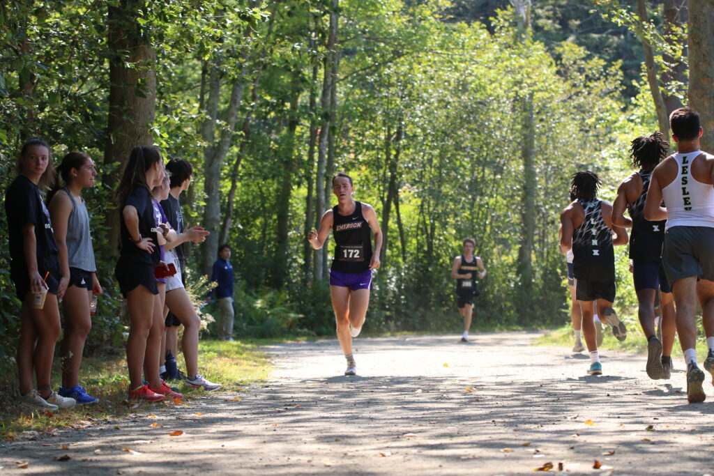 John Lanza running with female runners watching along