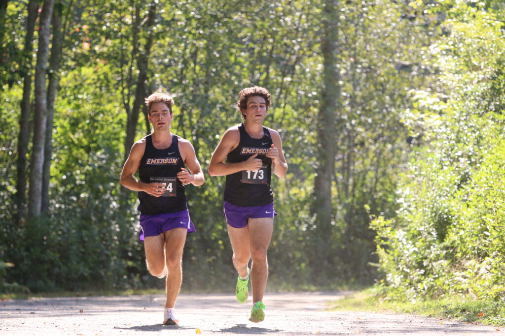 Zac Poulin and Joe Norris run next to each other in the meet