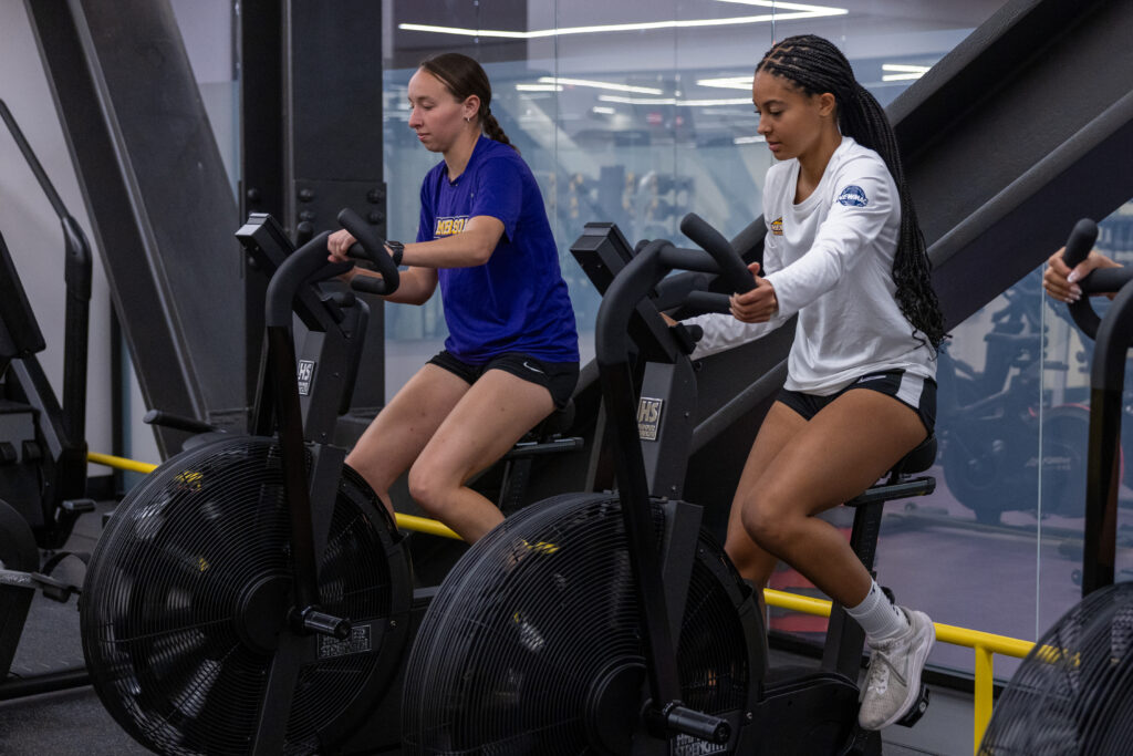 Samantha Zannotti and Sienna Parker use spin bikes