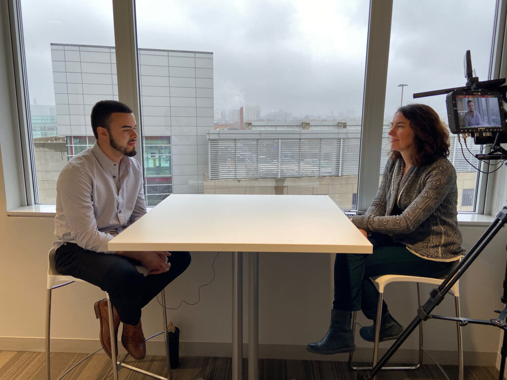 Juan Gallego speaks with Erin Trahan at a table